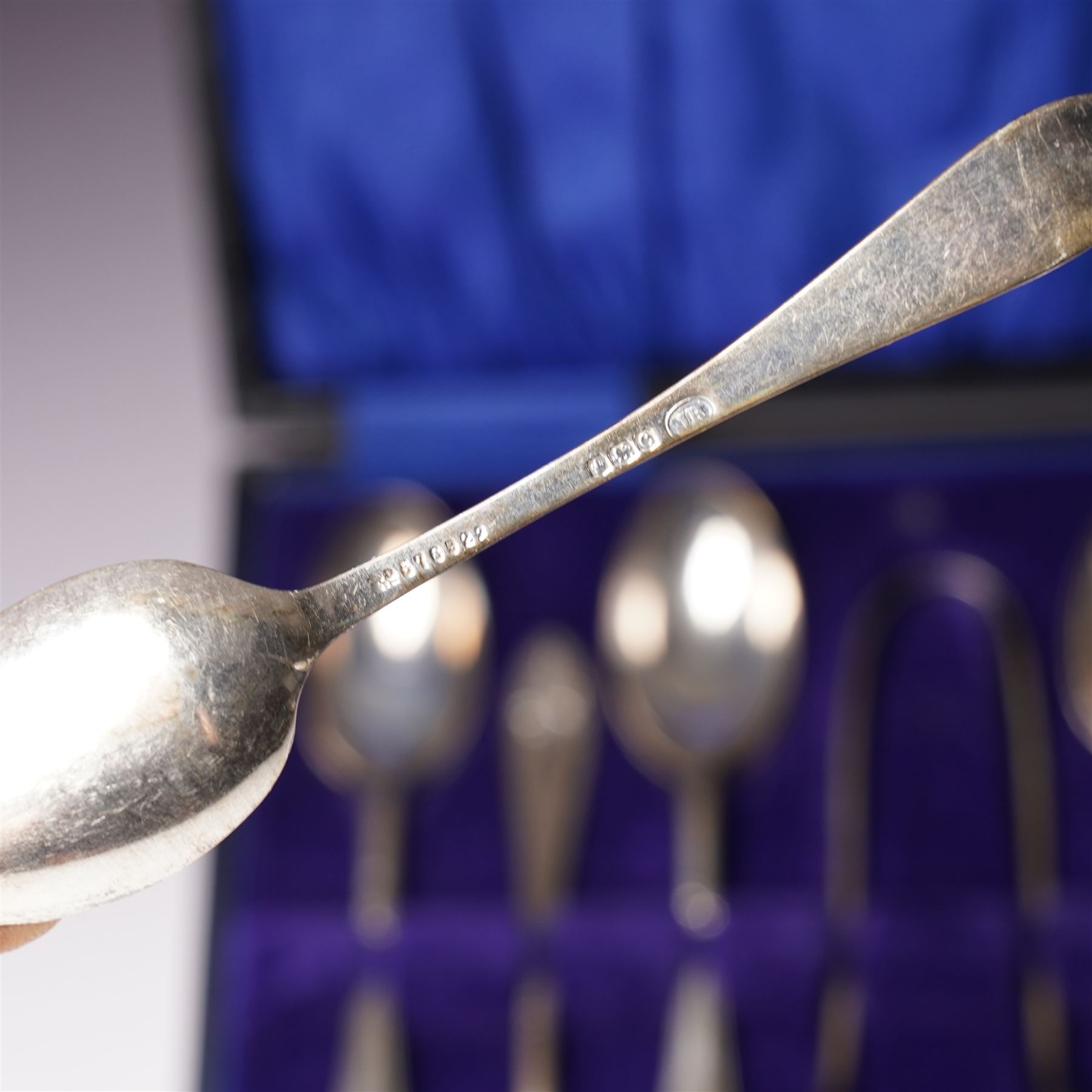 Set of  of six silver coffee spoons and tongs with bright cut decoration Sheffield 1908 Maker Cooper Bros. and another set of six coffee spoons with decorative terminals