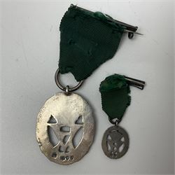 Victoria Volunteer Officers’ Decoration, V.R. cypher, hallmarked silver London 1892, with integral top riband bar and ribbon, unnamed; the matching miniature; and Victoria 'For Long Service in the Volunteer Force' miniature medal with ribbon in original case (3)