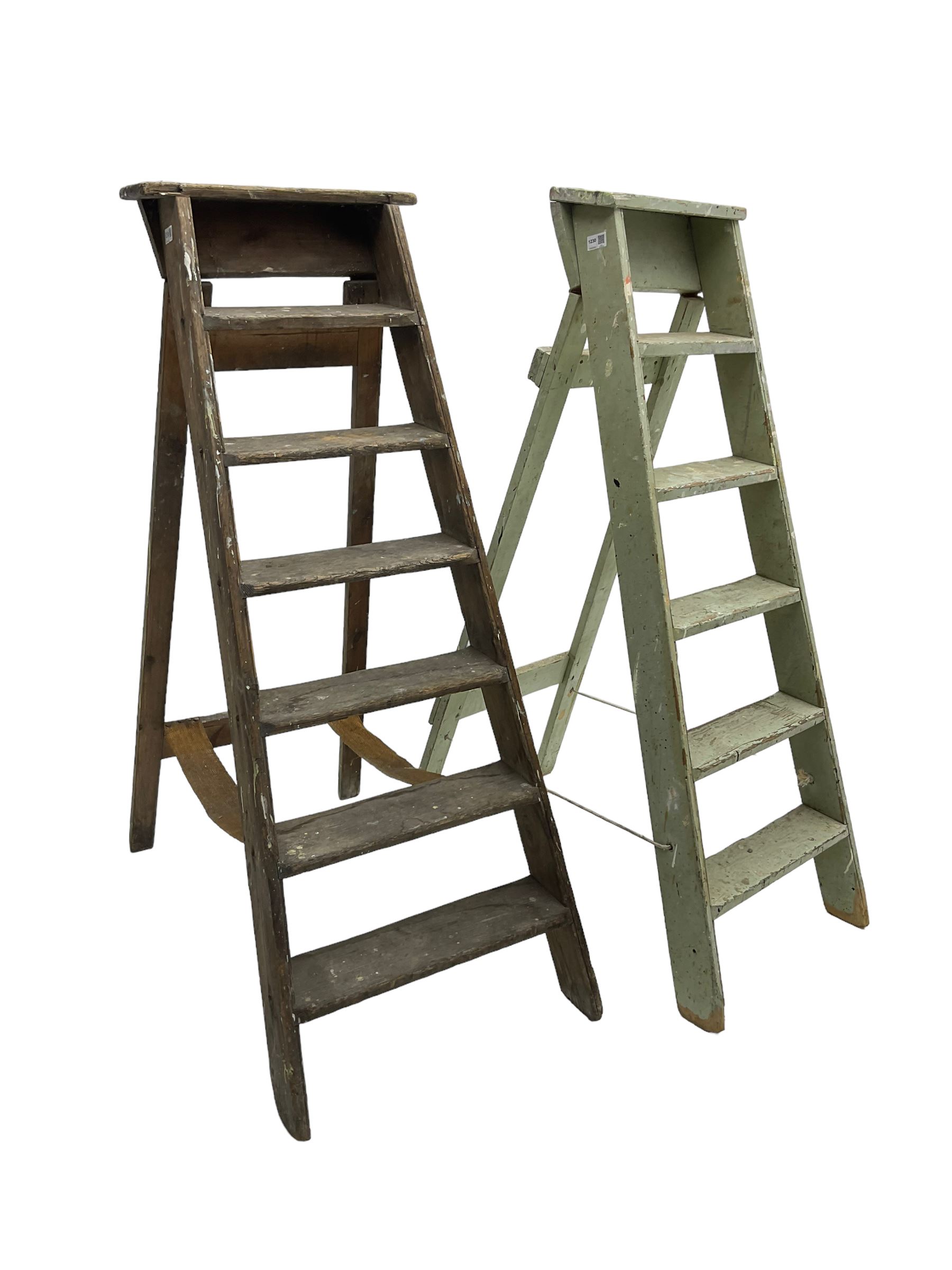 Early 20th century pine library or shop step ladder, seven tread (W45cm H135cm); together with another similar with painted laurel green finish (H135cm)