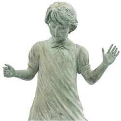 After Eneri Prosperi, bronze garden child statues, depicting children balancing on rock-form bases, the boy in shirt and shorts, the girl in dress with raised arms, surrounded by loose rounded pebble elements