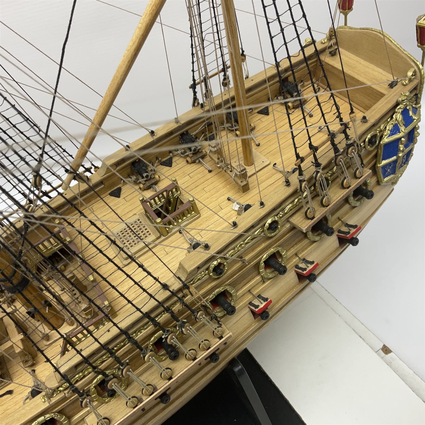 Wooden kit built model of HMS Neptune, 1:90 scale, with detailed rigging to three masts and a row of cannons to either side, upon ebonised wooden base, including stand H71cm