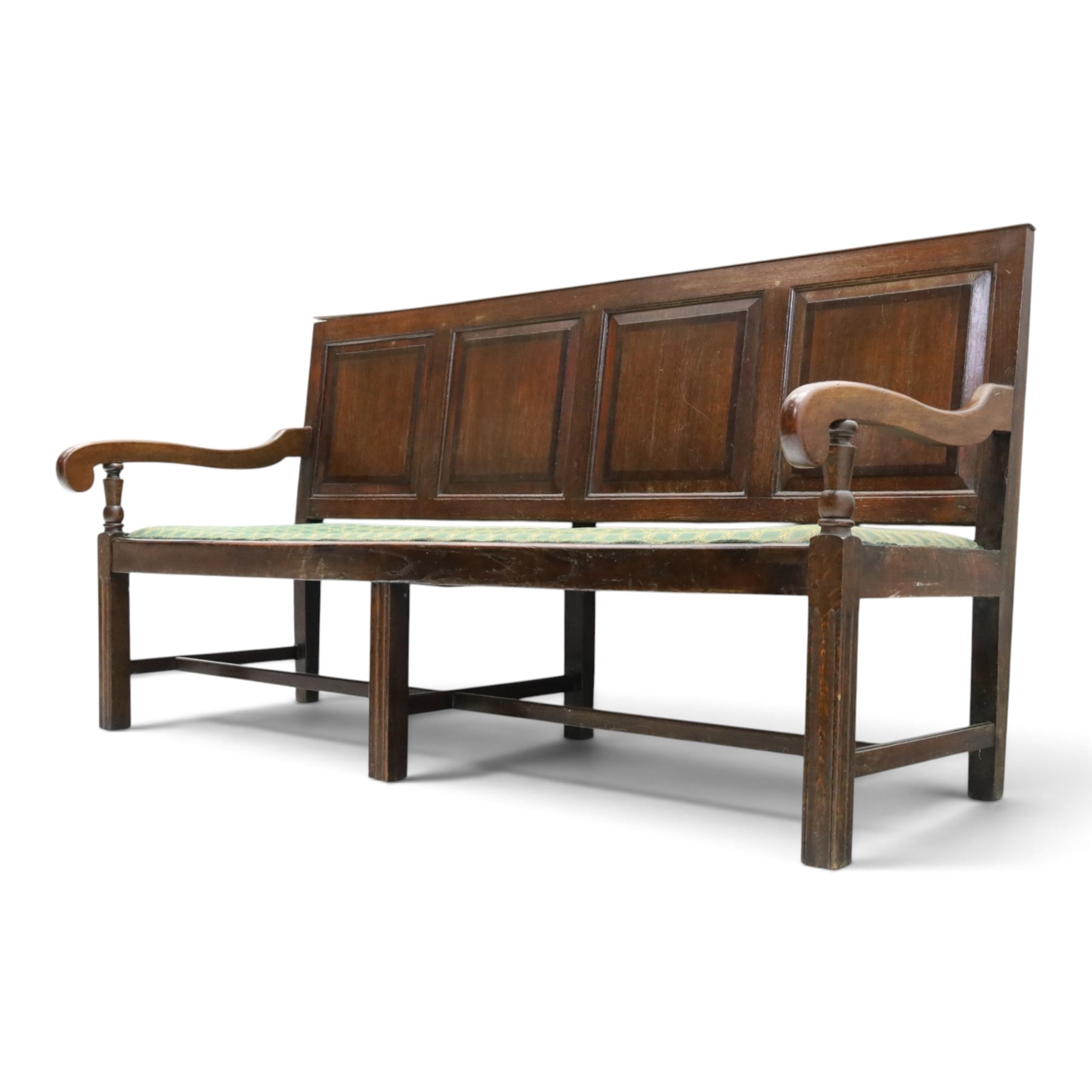 17th century design oak four panelled hall bench, fielded back panels flanked by swept arms on turned supports, raised on six supports united by a stretcher