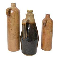 British, a stoneware jug and cover in the manner of Richard Batterham, together with two  stoneware gin flagons 