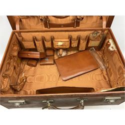 Vintage leather traveling case with monogram to cover, with watered silk lining to interior, and some contents, plus a further vintage travel case, (2)