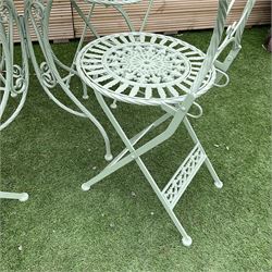 Circular wrought iron green painted garden table, and four folding chairs H75, D70 - THIS LOT IS TO BE COLLECTED BY APPOINTMENT FROM DUGGLEBY STORAGE, GREAT HILL, EASTFIELD, SCARBOROUGH, YO11 3TX