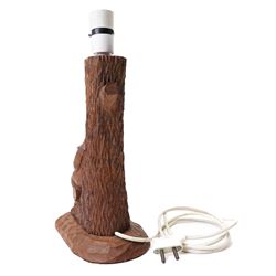 Gnomeman - an oak table lamp, with carved gnome figure seated on a log at the base of a tree stump, on a tooled base, by Thomas Whittaker of Littlebeck, H28cm excluding fitting
