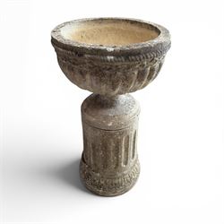 20th century good quality weathered cast stone pedestal urn of ecclesiastical design, circular lobed bowl with rope twist and lattice border, raised on squat base with fluted column  and acanthus decorated base