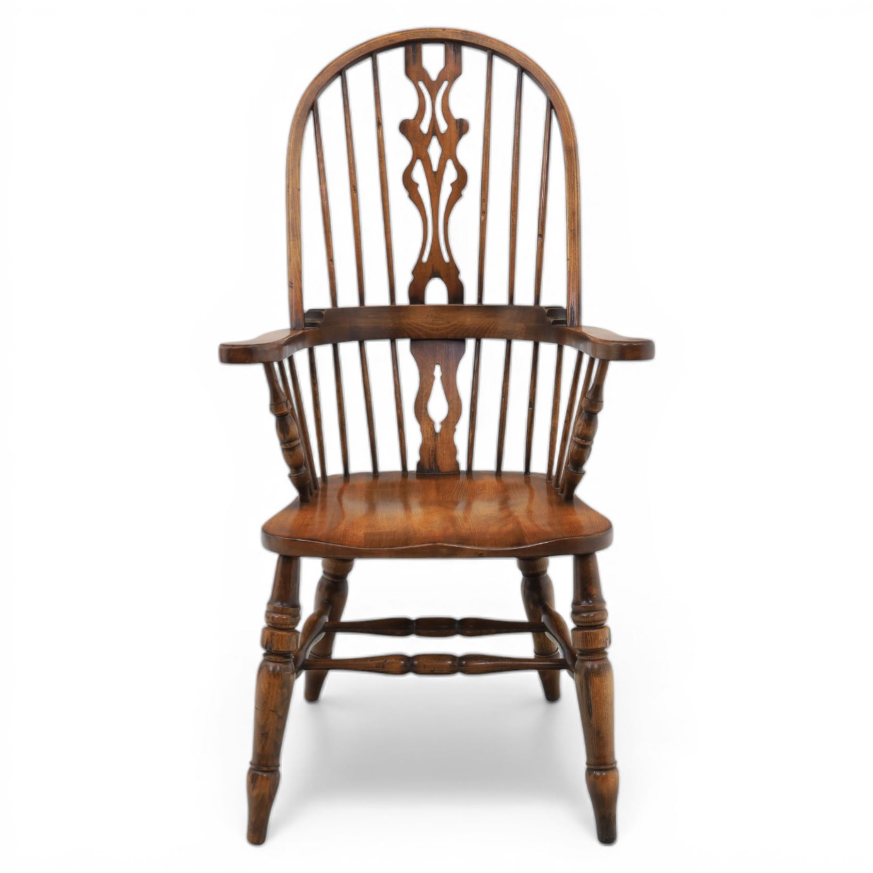 Late 20th century elm and beech high back Windsor armchair, the arched hoop back with pierced vase shaped splat between turned spindles, shaped arm rail on turned supports, saddle seat, raised on turned legs united by a crinoline stretcher
