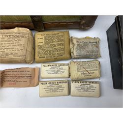 WW2 British Army RAMC 'Regimental Medical Pannier', well marked externally and dated 1941, stamped May 1943 internally, canvas covered wicker form with leather edges, hinged top and fall front with two rope carrying handles, fitted iron locking straps with securing chains; contains various unused field dressings and bandages with WW2 dates and two pillows; original label under lid L79cm