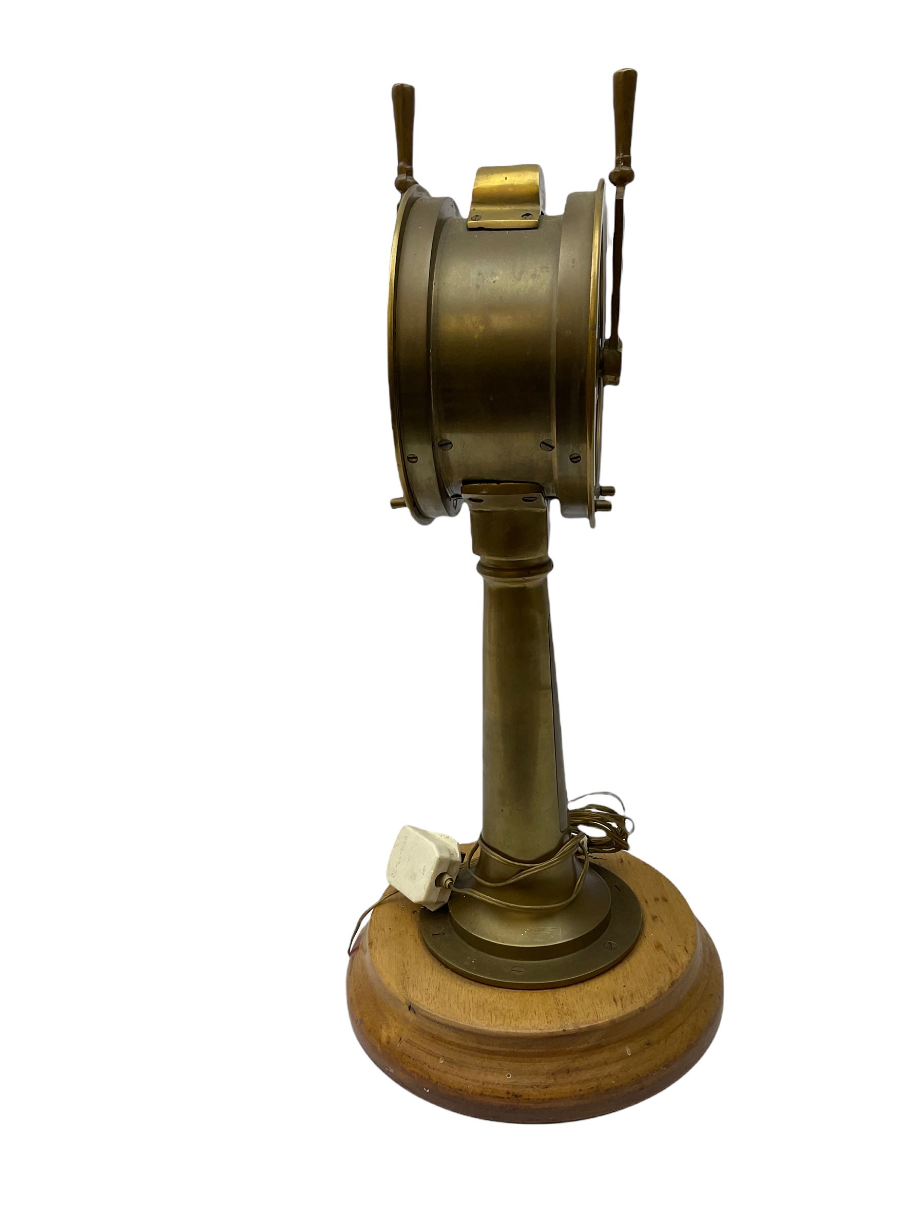 Early 20th century, illuminating brass ship's telegraph by Chadburns of Liverpool and London, on a circular wooden plinth, H55cm