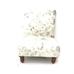 Wide seat nursing chair upholstered in an ivory ground fabric with floral pattern, turned supports, W63cm