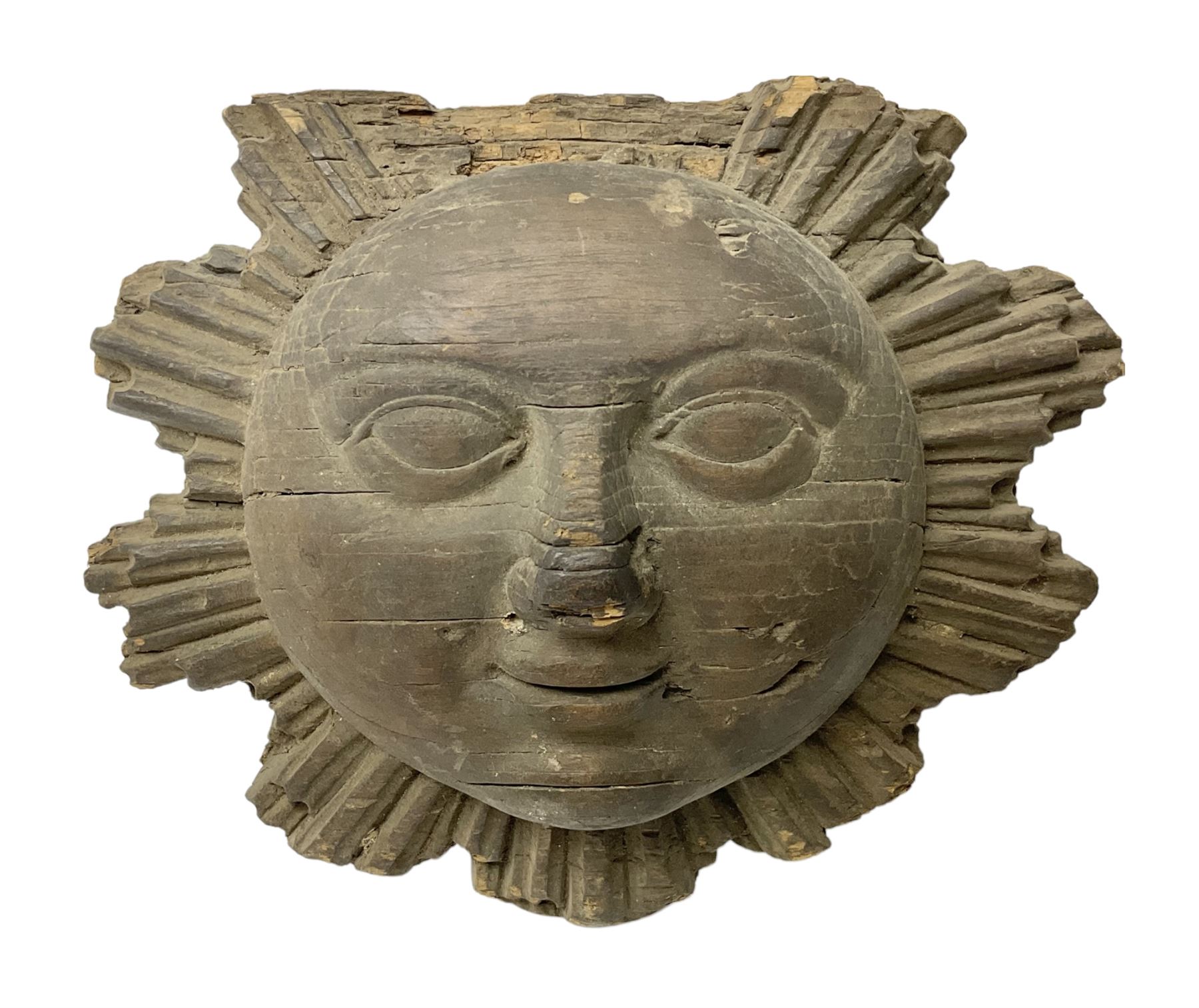 Carved pine mask of the sun, probably late 17th/early 18th century, originally a cresting, bearing Christie's lot labels, D20cm

Provenance 
Lot 161, Christopher Howe - The First Twenty Years, Christie's. 24th March 2004
