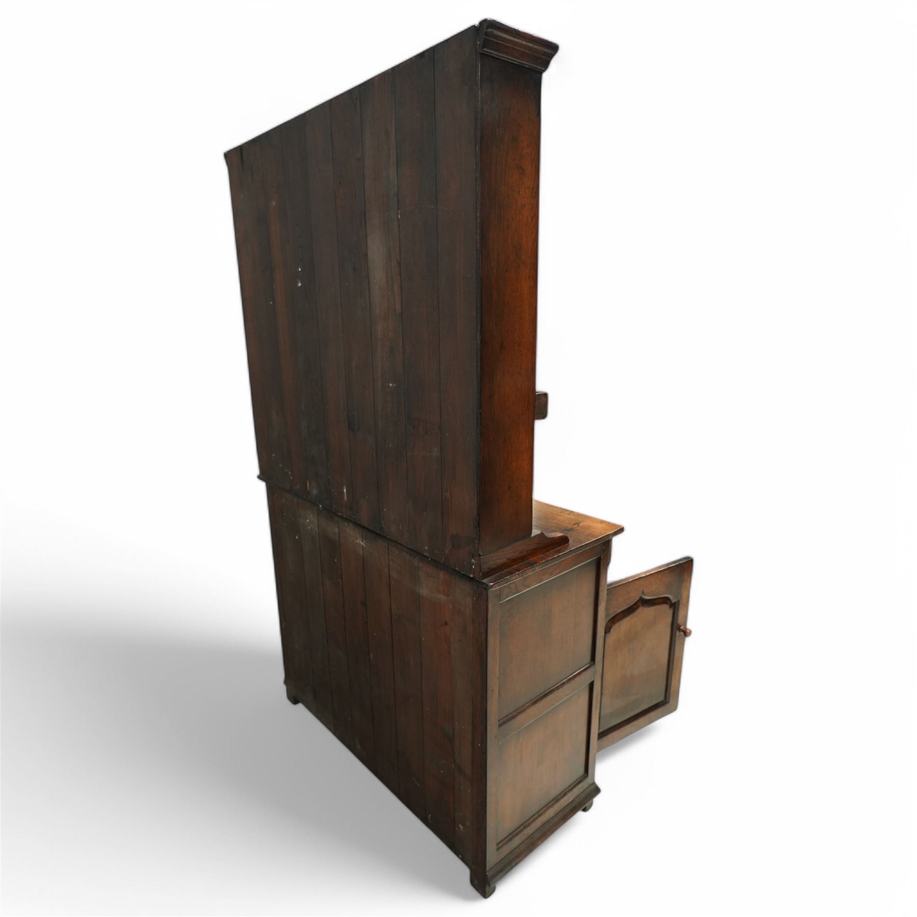 Contemporary georgian style oak dresser, open rack top with two shaped shelves and small side drawers, base with rectangular top over two drawers with brass swing handles, twin arched panelled doors below, on bracket feet
