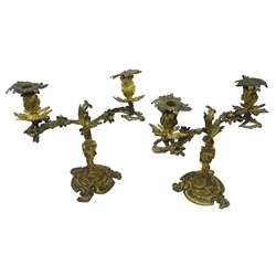  Pair of late 19th century Rococo Revival bronze two branch Candelabra, urn shaped sconces on floral scroll branches, eagle and scroll column and shaped circular base, H36cm, W37cm (2)  