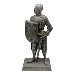 Cast iron fire companion set modelled as a knight in armour with fleur-de-lis shield and sword concealing fire poker, with brass tongs to reverse, raised upon stepped rectangular base, H55cm