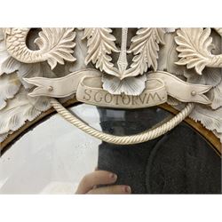 Pair 19th century French Dieppe bone and ivory wall mirrors, the oval bevelled mirror plates within rectangular frames with shaped tops, profusely decorated with ivory leaves, further detailed with carved bone armorial type crest inscribed 'SGOTORVM', putti, fish and mask heads, H81cm W48cm