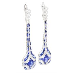Pair of platinum sapphire and diamond pendant earrings, each stud milgrain set with a single oval cut sapphire, surrounded by calibre cut sapphires and single cut diamonds, suspending from six graduating articulated panels, to four single cut diamonds, total sapphire weight approx 3.80 carat, total diamond weight approx 0.80 carat