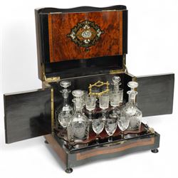 19th century French Boulle-style cave à liqueur or travelling decanter set, with musical mechanism playing carrara bonne de ay and Locked in the old Kent Road, the walnut box of serpentine front, the hinged lid with central brass and mother of pearl cartouche, with removable wooden tiered tray with gilt metal handle, containing four foliate etched glass decanters and sixteen glasses, H27cm