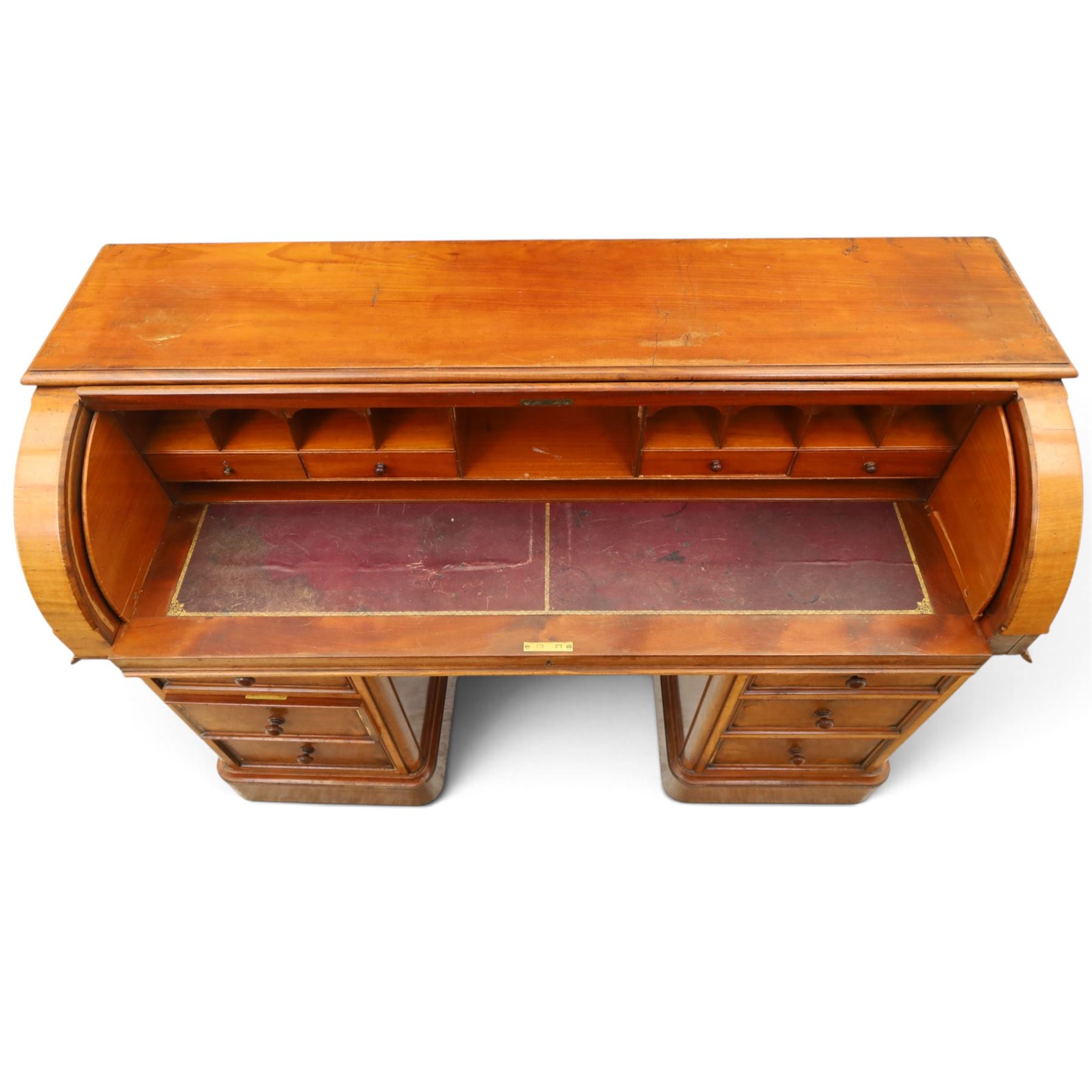 Victorian mahogany twin pedestal cylinder desk, with roll top with fitted interior and with leather writing slide, raised on pedestals with three graduating drawers, raised on a plinth base with castors