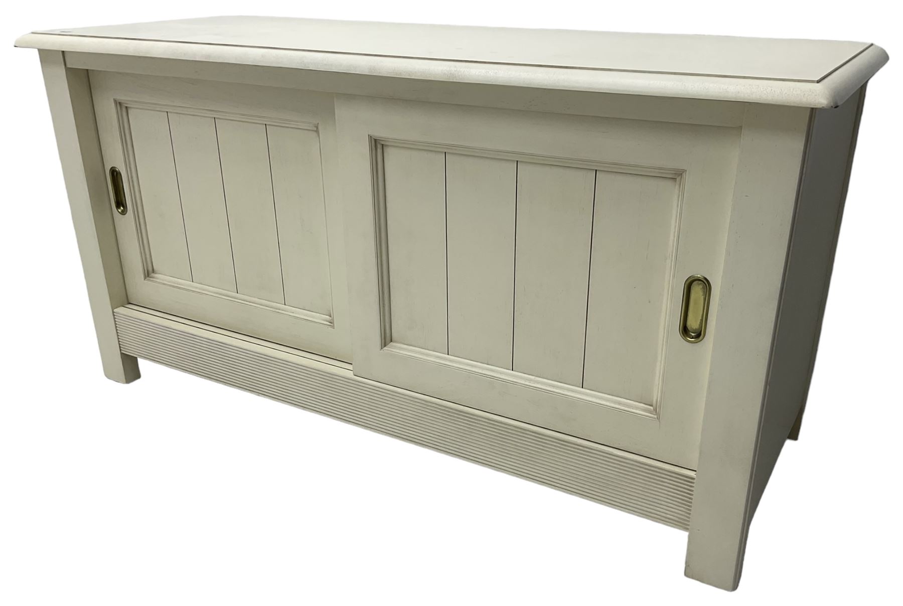Cream finish low side cabinet, moulded rectangular top over two sliding panelled doors, on stile supports 