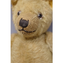  Early 20th century teddy bear, the plush covered body with squeaker mechanism, revolving head with applied eyes and stitched features to the pronounced snout, humped back and jointed limbs with upturned paws to the arms H52cm  