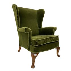 Parker Knoll wing back armchair, upholstered in green fabric