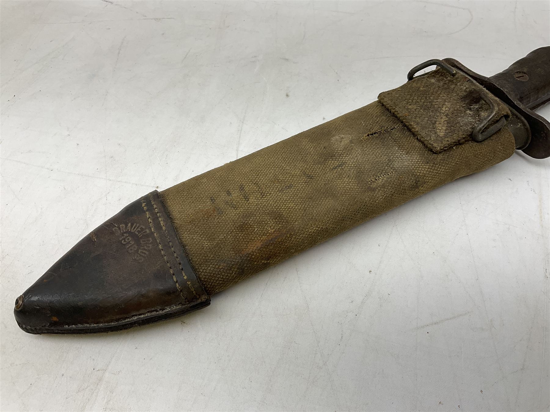 US Model 1910/17  Machine Gunners Bolo knife, the 26.5cm curving steel blade marked 'US MOD 1917 PLUME PHILA 1918'; in webbing covered steel scabbard with leather chape marked 'Brauer Bros 1918' L40.5cm overall (with photocopy of modern reference material)