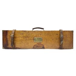 Early 20th century leather and brass mounted gun case, with vacant brass plaque to cover, twin leather straps and carry handle, opening to reveal and green baize lined interior, L81cm