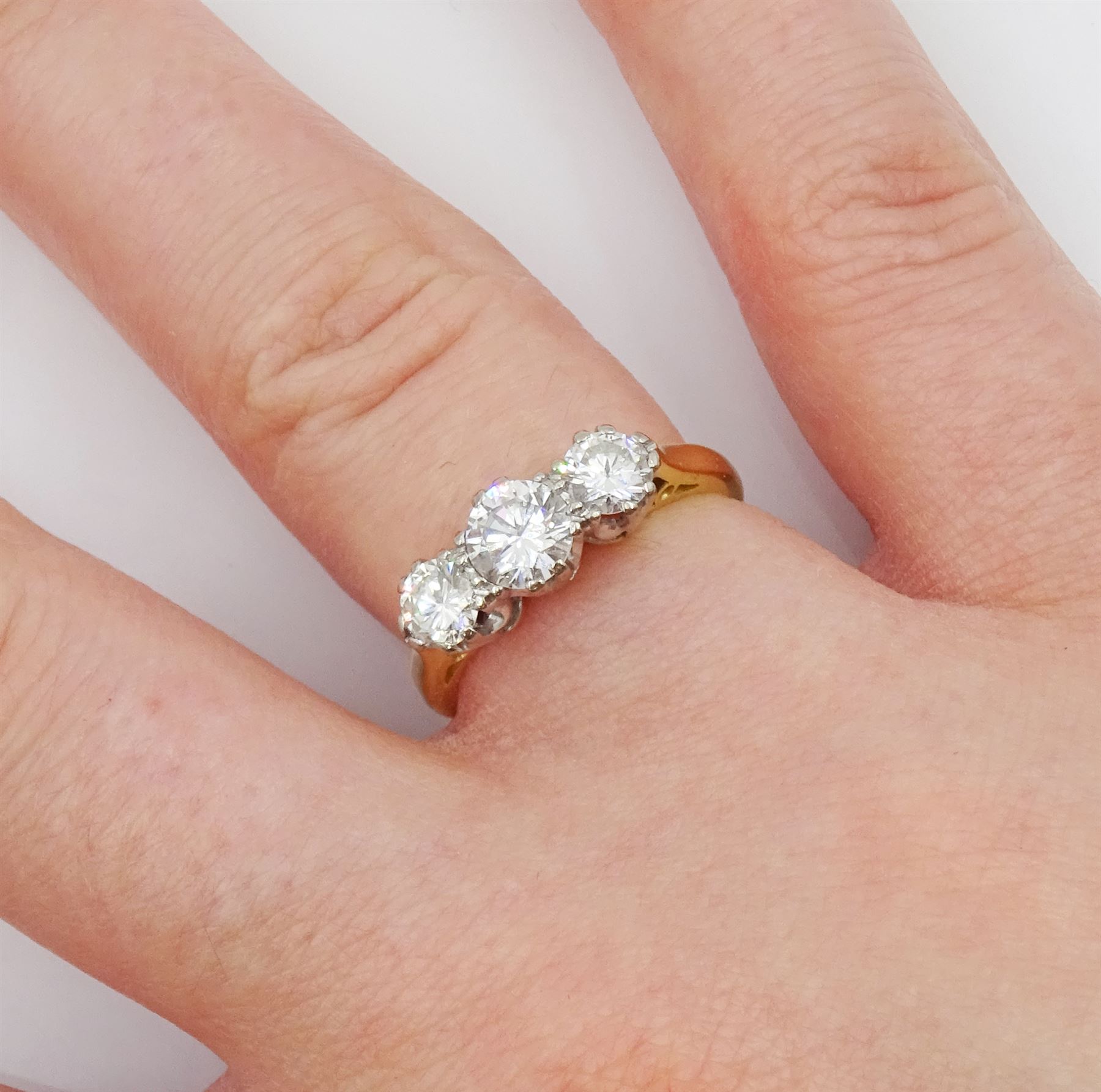 18ct gold three stone round brilliant cut diamond ring, stamped total diamond weight approx 0.95 carat 
