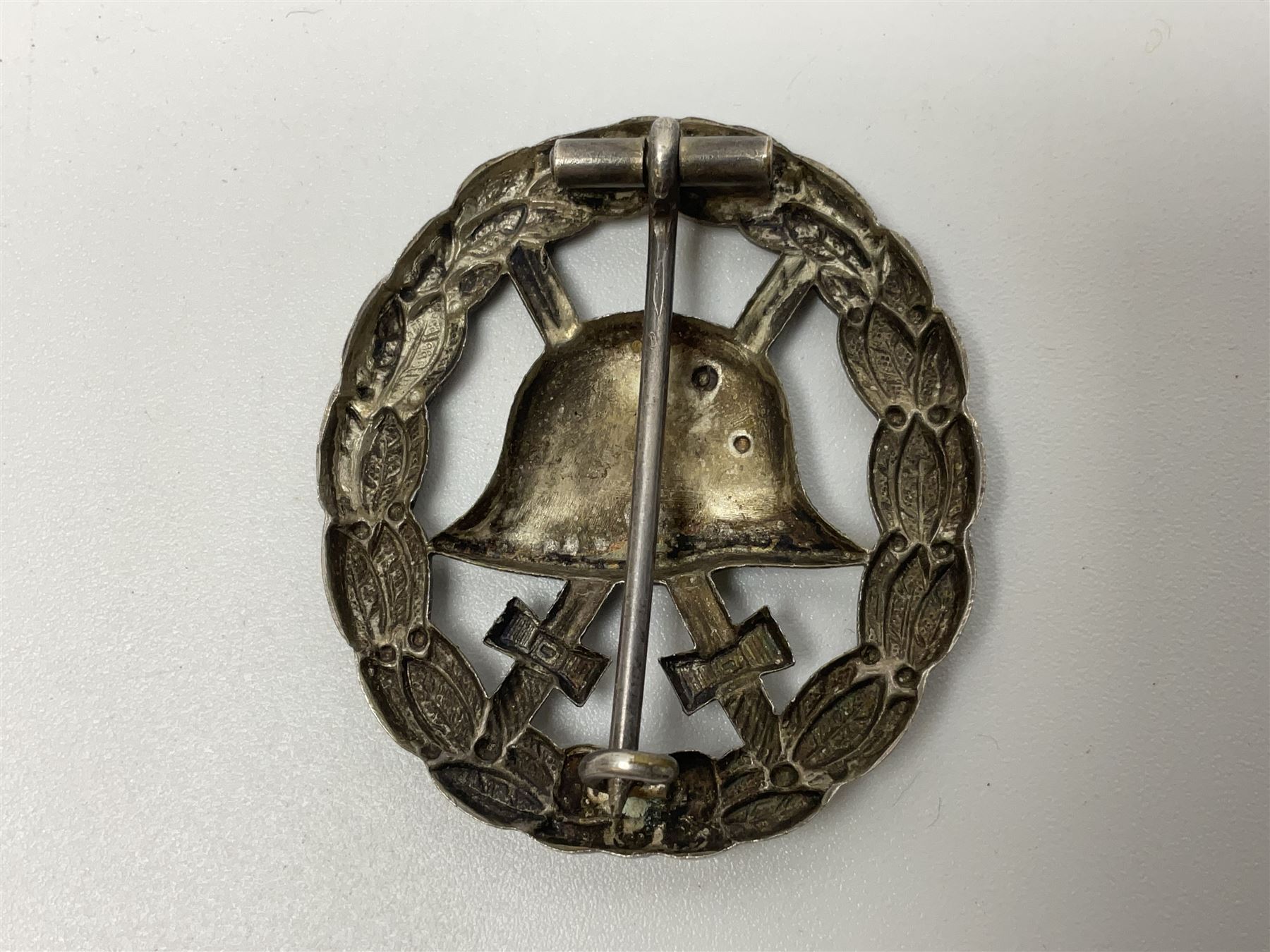 Four German awards - pre-WW2 two-position button hole ribbon for 1914 Iron Cross; WW1 wound badge open back cut-out version with silvered finish; miniature version Mother's Cross with ribbon bow; and The Eastern Medal, officially the Winter Battle in the East 1941–42 Medal (4)