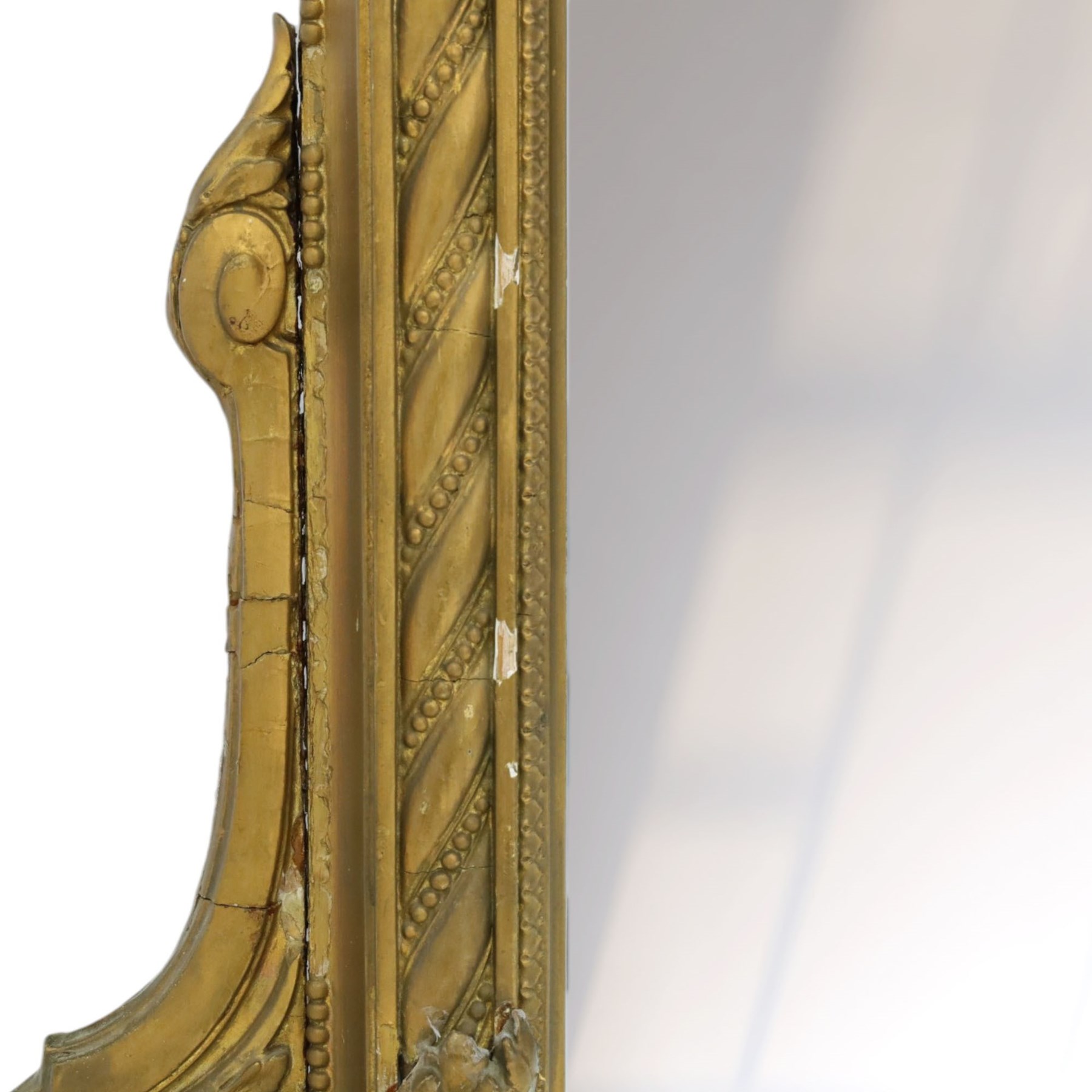 Large late 19th century gilt framed overmantel mirror, urn pediment above a foliate and Greek key frieze, egg and dart beaded edges, enclosing a plain mirror plate, with scrolled lower sections