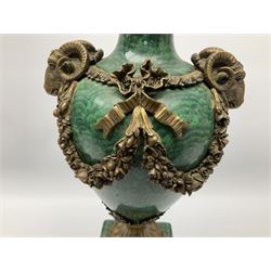 Pair of Neo-Classical style malachite effect table lamps, the urn shaped bodies with applied bronzed ram masks, and ribbon and floral swags, each upon an acanthus mounted circular spreading foot, and malachite finished plinth with applied bronzed panels of classical female figures, and four compressed circular feet, not including fixtures H47cm
