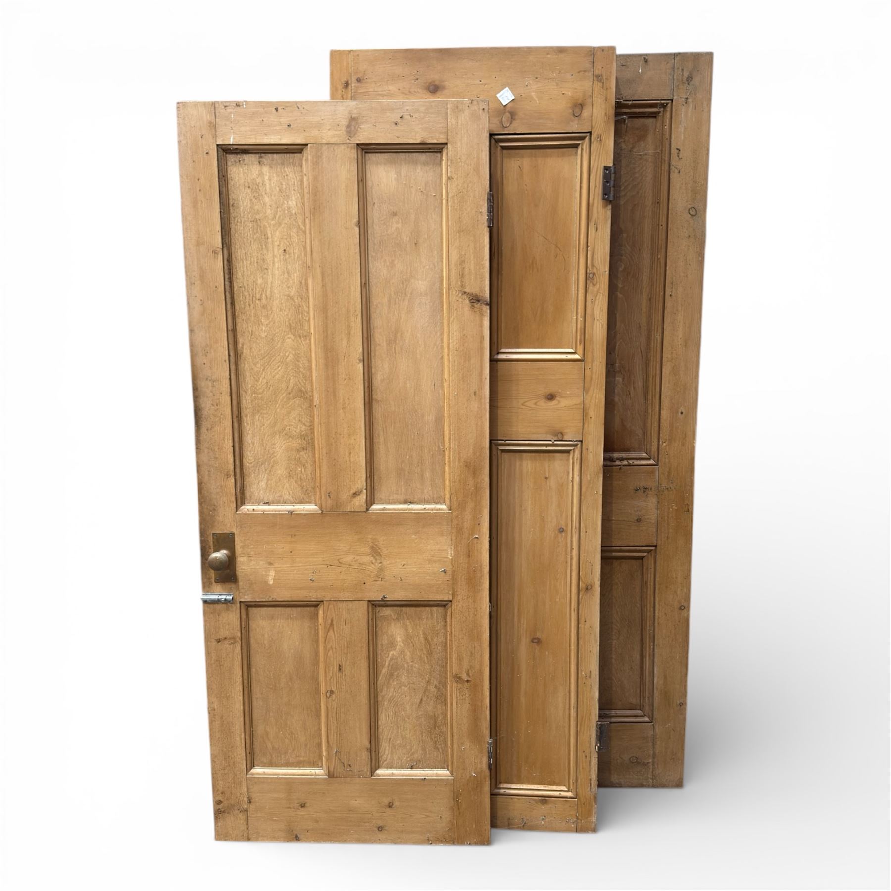 Three reclaimed pine doors with brass handles 