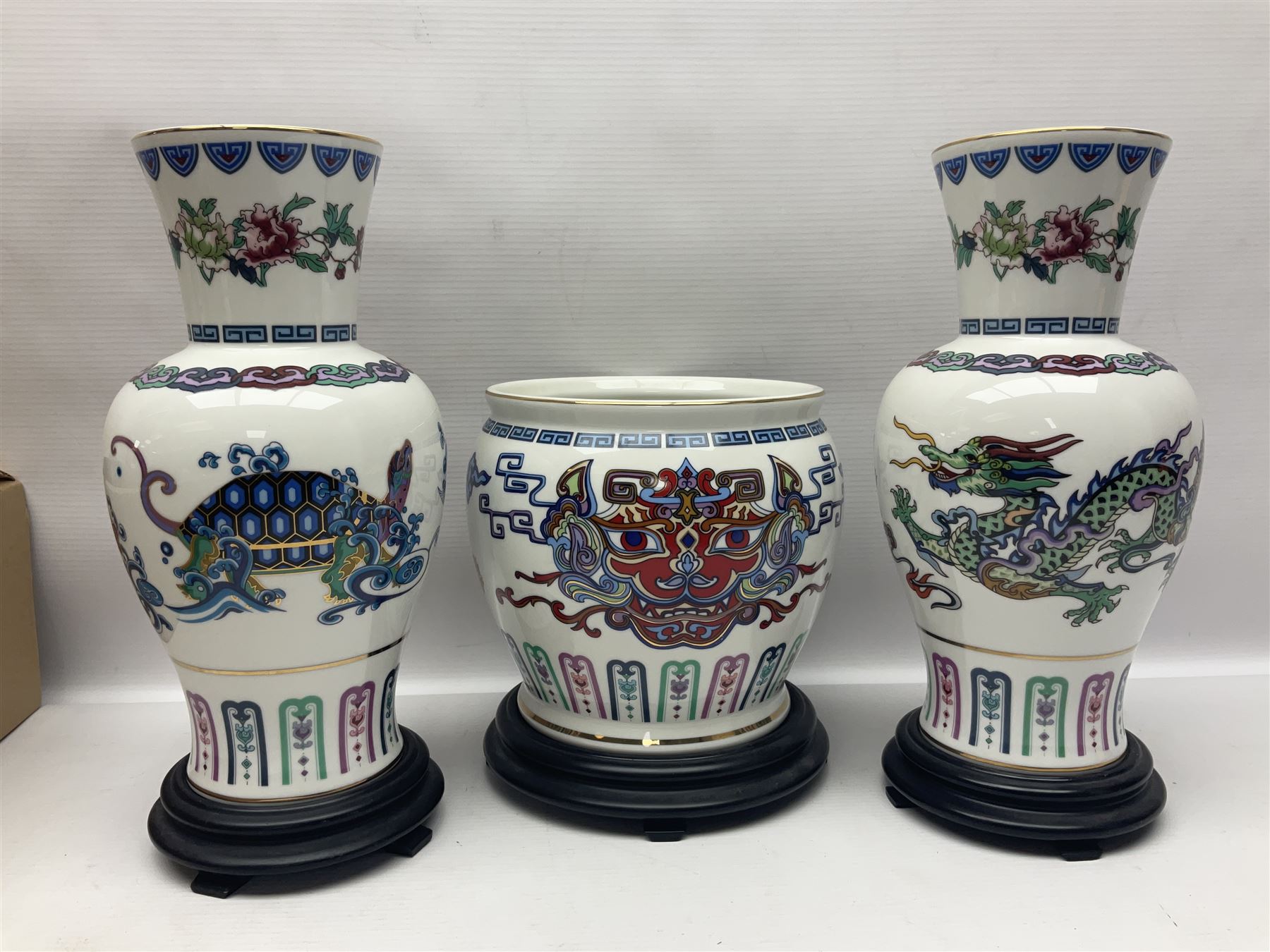 Franklin Mint Chinese style ceramics, comprising two vases, puppy and a planter, all on wooden stands