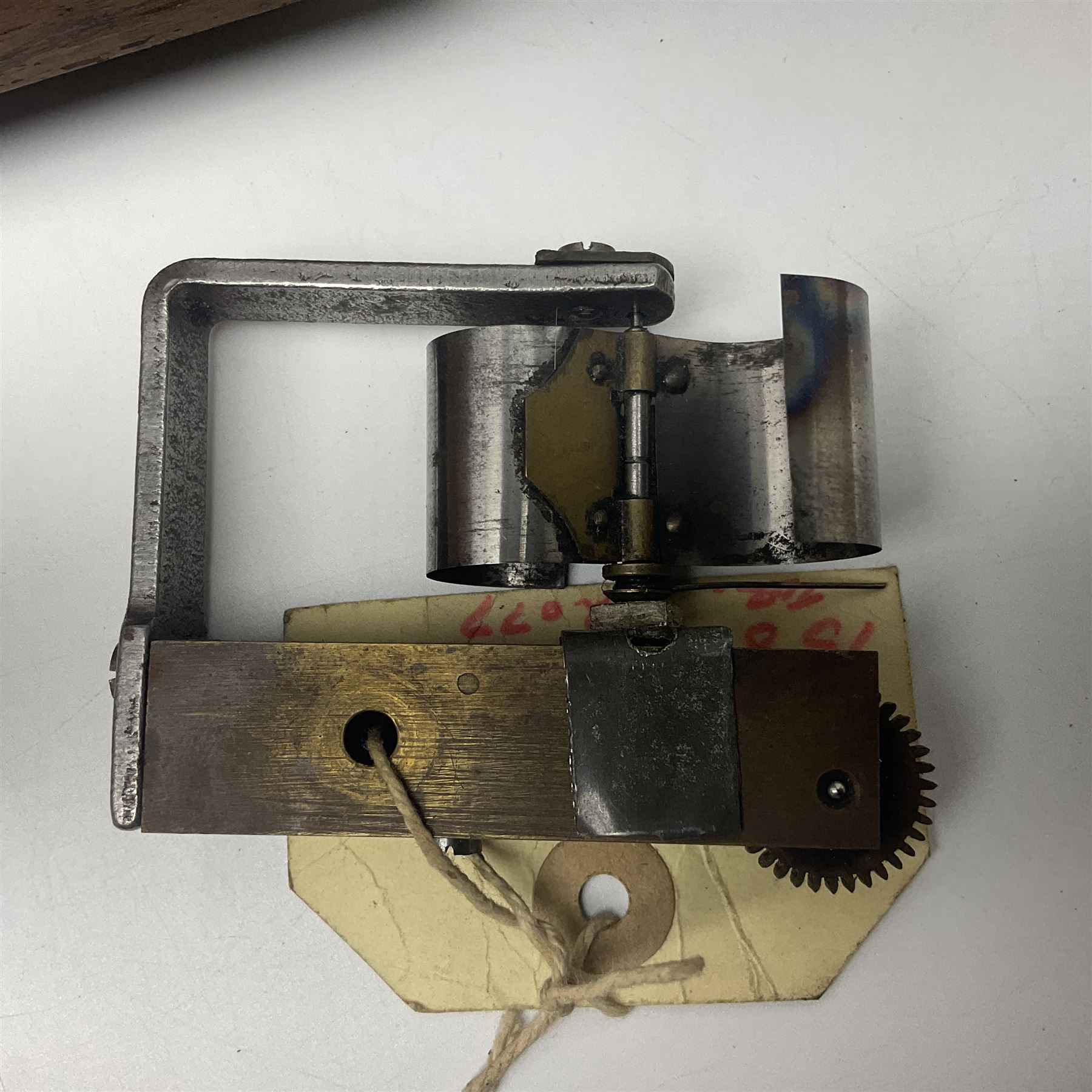 Late 19th century Symphonion disc musical box for spares or repair, inlaid walnut case with front lever action, playing 25.5cm discs on a 10.5cm steel comb with forty-nine teeth, musical scene of cherubs under the lid, L33cm; together with twelve 25.5cm discs