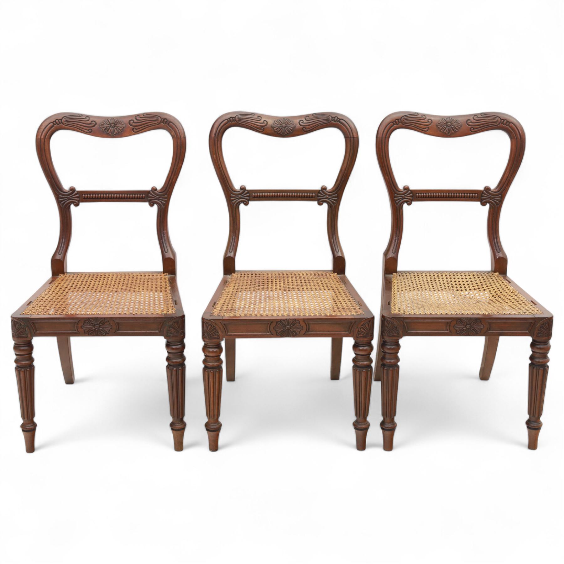 Gillows - Set of six mahogany dining chairs, each with curved top rail carved with floral medallion and scroll detail, fluted front supports, caned seats, the seat rail underside stamped HH identified as H. Howse an apprentice cabinetmaker at Gillows.