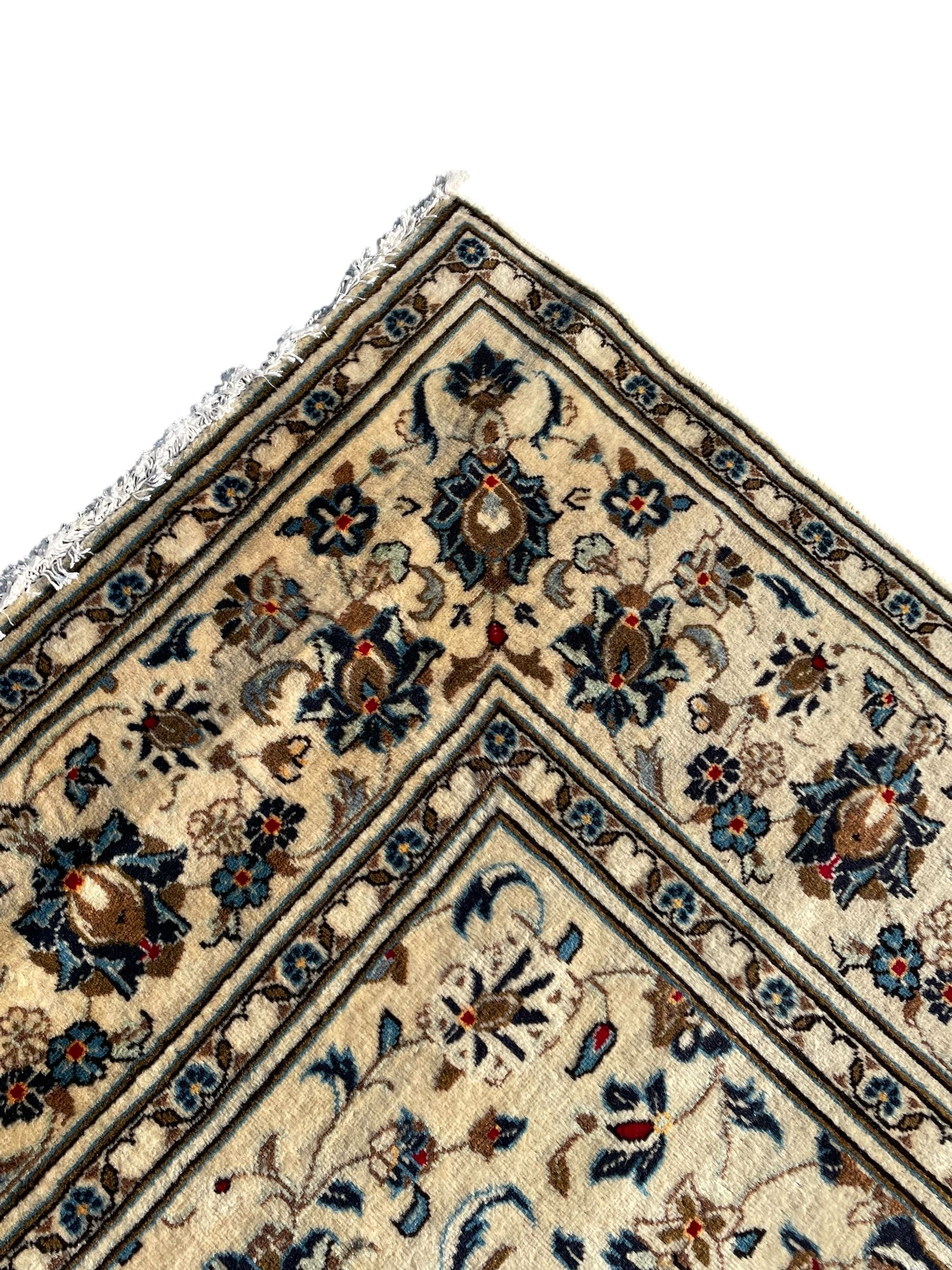 Persian Nain ivory ground rug, the field decorated with trailing leafy branches and palmettes, matching border within guard stripes