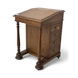 19th century pitch pine Davenport desk, sloping hinged top, fitted with four drawers, on turned column supports, turned compressed feet with castors 
