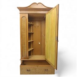 Victorian satin walnut single door wardrobe, shaped cavetto cornice above a central arched mirrored door flanked by recessed panelled sides, the interior fitted with hanging space and later added corner shelves, over a single long drawer with brass handles, on a plinth base