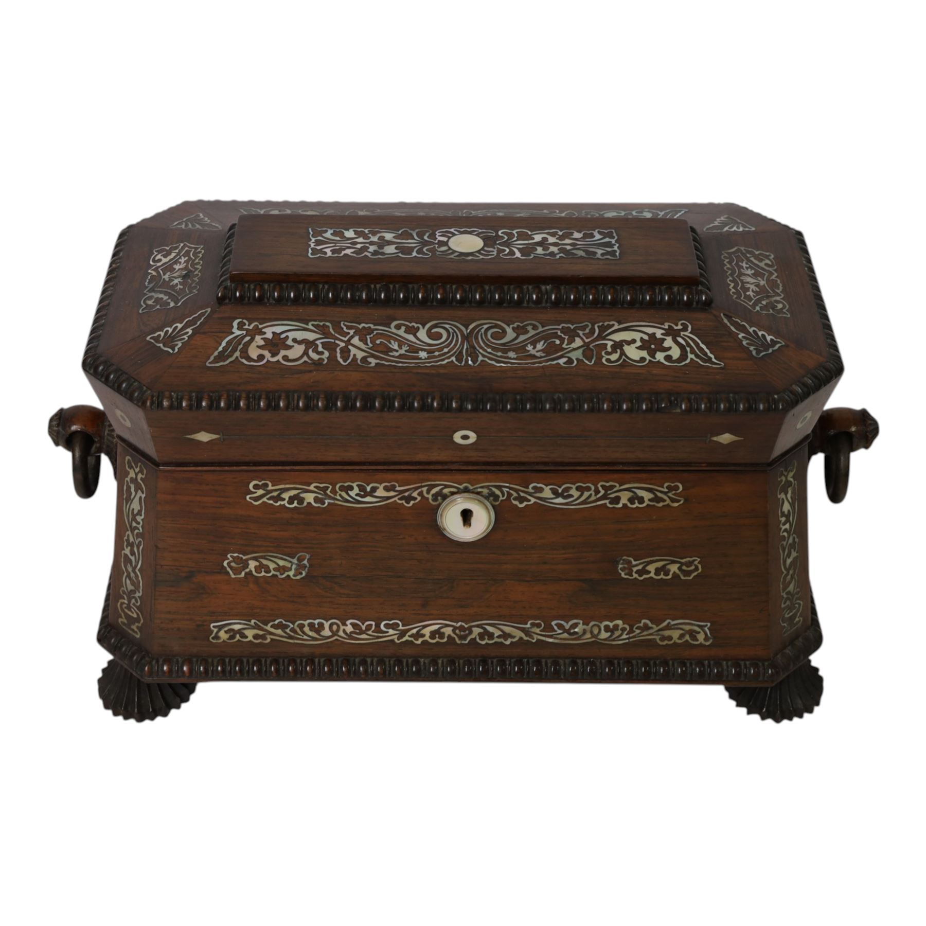 Tea caddy of sarcophagus form, inlaid with mother of pearl decoration,  the hinged lid opening to reveal two covered compartments, H24cm 