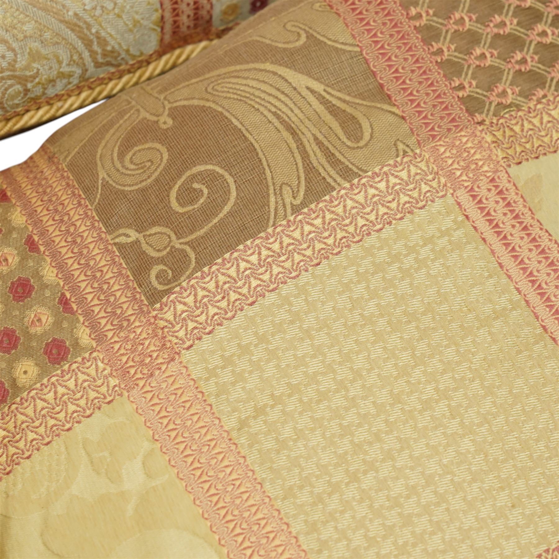 Contemporary set of six jacquard woven scatter cushions, each with a patchwork effect of floral, damask and dotted motifs in a palette of gold, blush, and cream, piped edging throughout, together with a square cushion with embroidered tree and bird design on a cream linen ground (H 40cm, W 40cm, D 14cm)