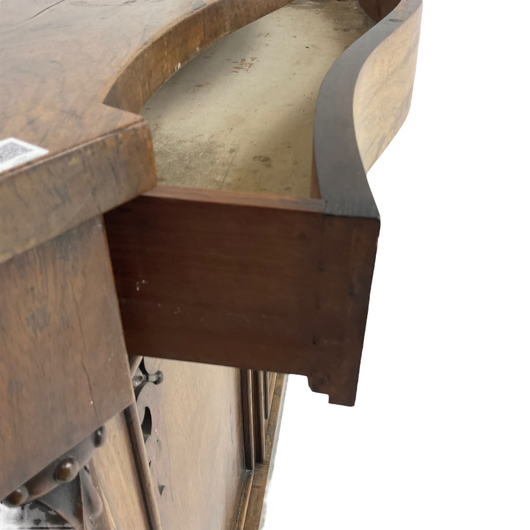 William IV rosewood serpentine chiffonier, fitted with frieze drawer over two panelled cupboard doors with applied C-scroll decoration, flanked by canted uprights with moulded foliate corbels