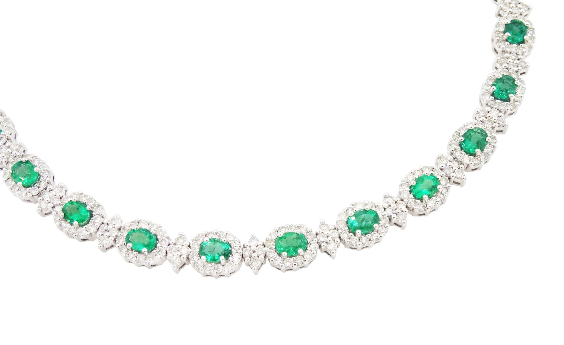 18ct white gold emerald and diamond necklace, fifteen oval cut emeralds, each surrounded by twelve round brilliant cut diamonds and spaced by a further four diamonds, to a fancy openwork oval and bead link necklace, stamped, total emerald weight approx 3.30 carat, total diamond weight approx 2.45 carat