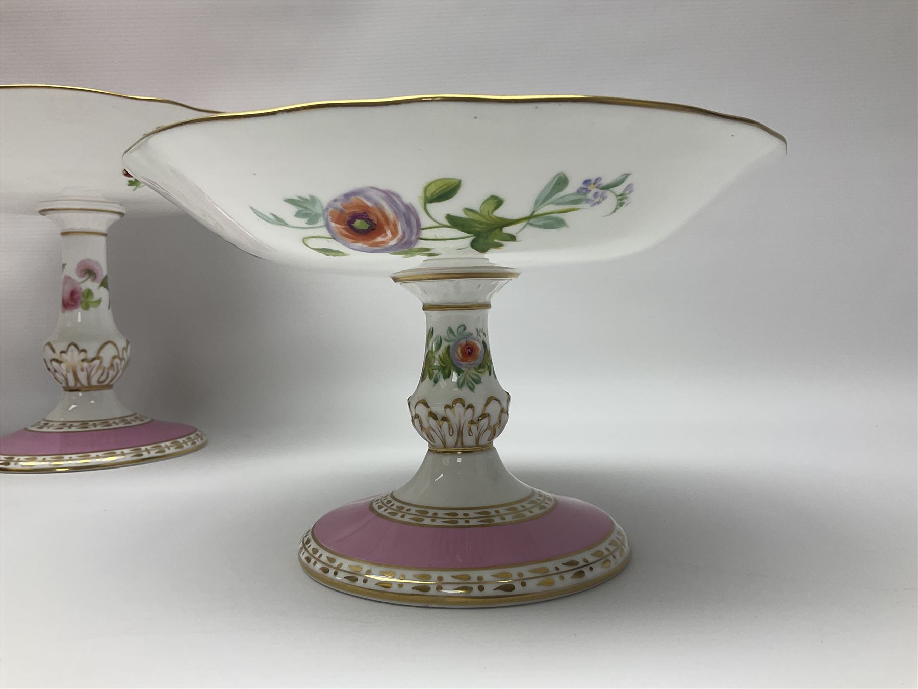 Victorian Copeland, Botanical dessert service, decorated with floral sprigs to the centre with a pink and gilt border, comprising five comports and seven plates, largest comport H20cm, plate D22cm