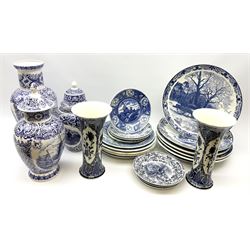 A large collection of modern transfer printed Delft ware, to include large baluster vase, H42cm, two jars and covers, largest H40cm, pair of tapering cylindrical vases, H31cm, and a number of plates of various size and design. 