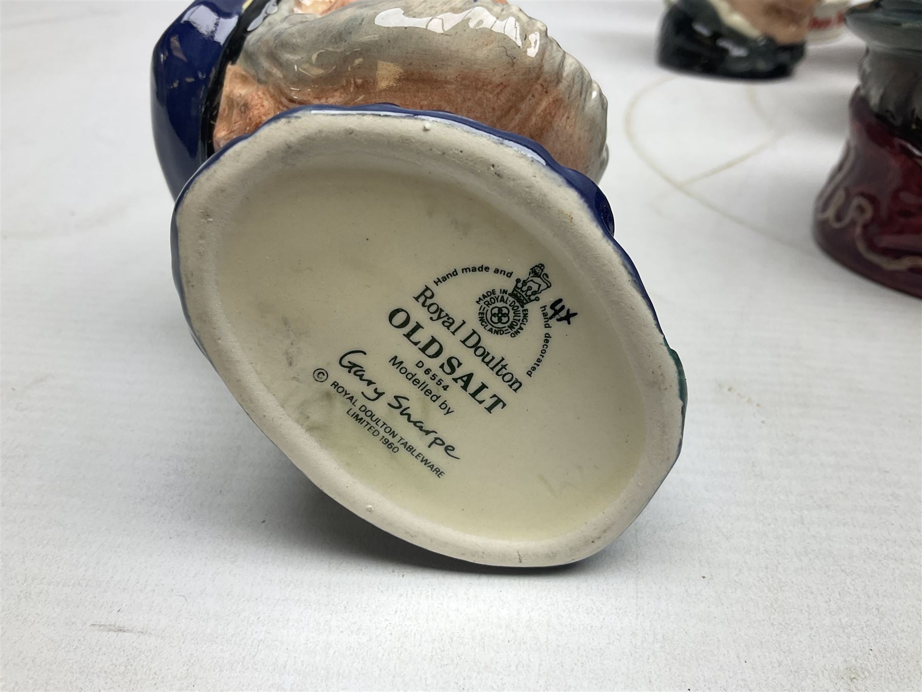 Large collection of Royal Doulton miniature character jugs, to include The Postman D6801, The London 'Bobby' D6762, Old Salt, D6554, Sir Henry Doulton D6703 etc  
