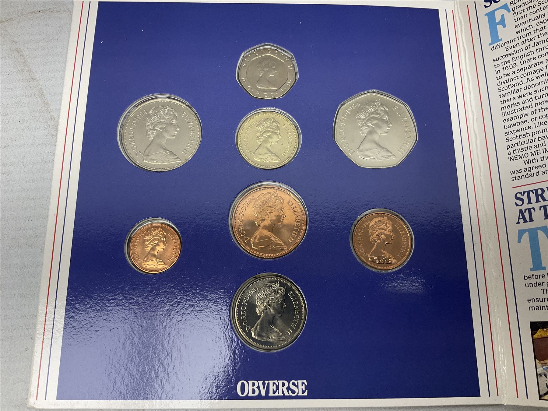 The Royal Mint United Kingdom 1984 brilliant uncirculated coin collection, 1997 and 2001 commemorative crown coins, 1997 old round one pound, all in card folders and four sterling silver medallic first day covers from the 'Great Britons' collection housed in a blue folder