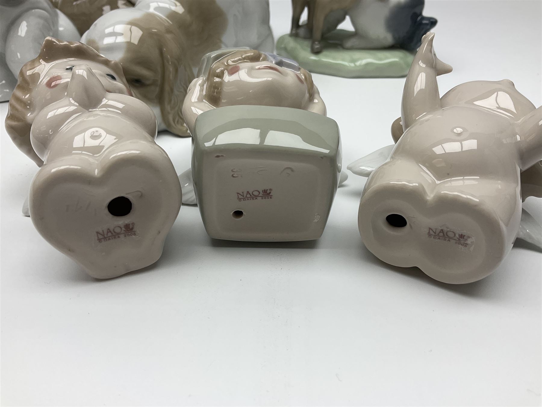 Ten Nao figures, to include three Cheeky Cherubs, Cat, Dog bride and groom etc