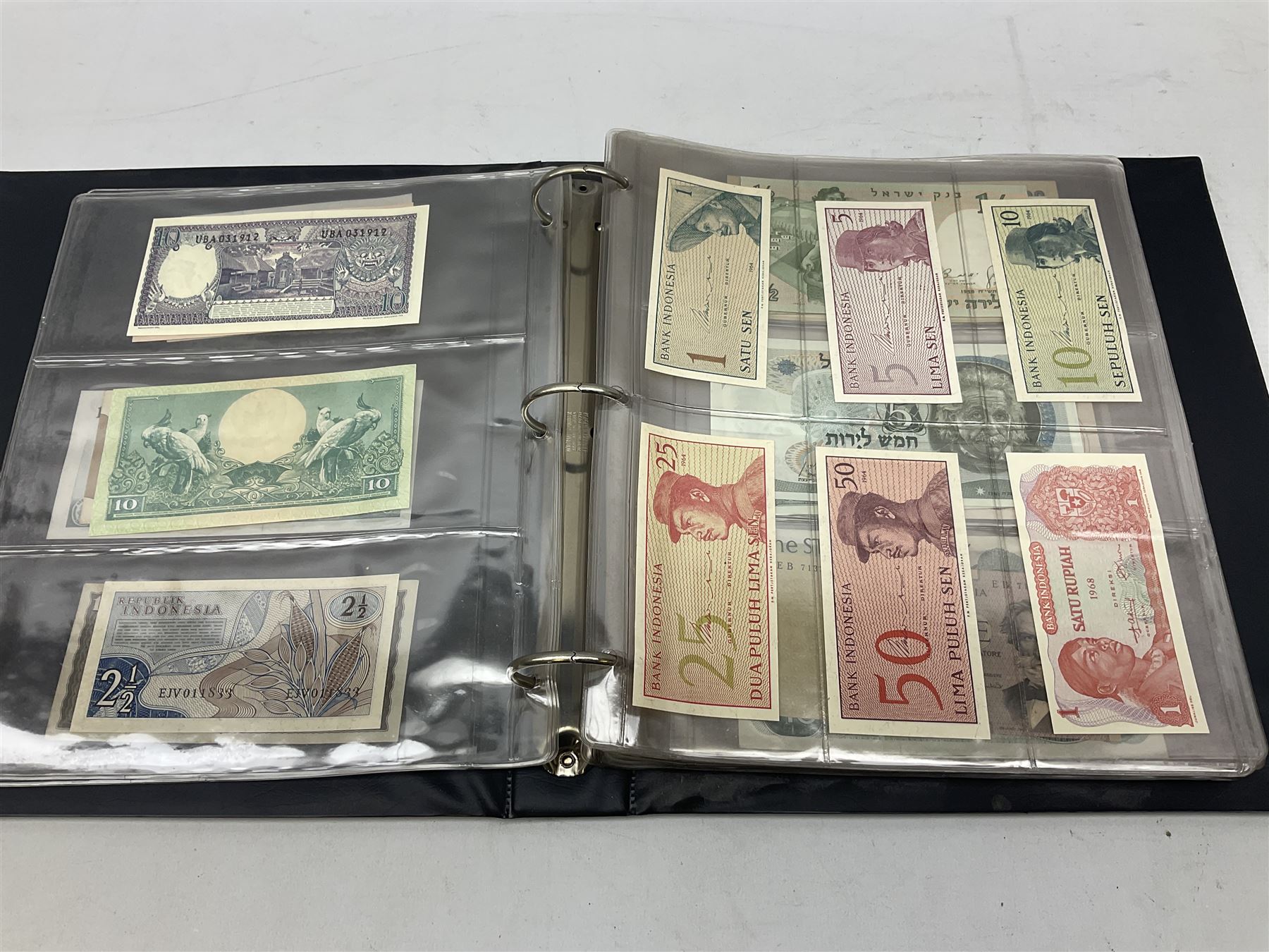 World banknotes, including Queen Elizabeth II The States of Jersey one pound 'DB202703', five pounds 'BB527762' and ten pounds 'AB651481', reserve bank of New Zealand two dollars '1L3 741894', King George V Straits Settlements one dollar 1st January 1935 'F/83 28924', various Bank of England notes etc, housed in two ring binder albums