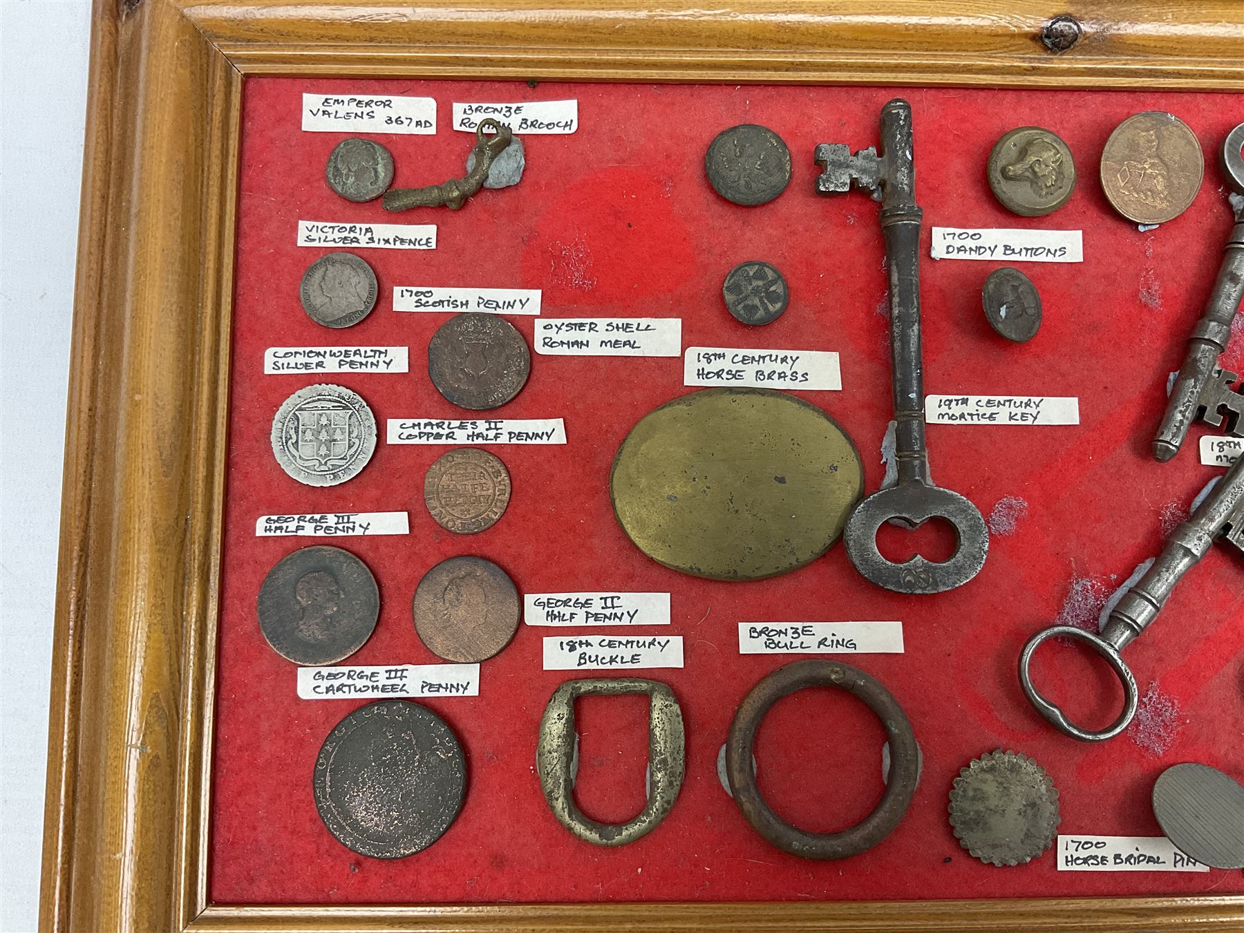 Collection of metal detecting finds and antiquities, housed on five display boards and some loose, to include coins, keys, axe head etc 